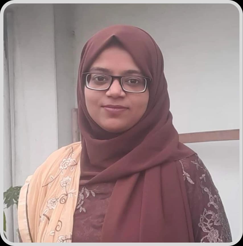 A woman in a blue shirt stands with arms crossed, representing Tasmia Tahrin Mahmud, Senior Content Writer at Rankupper.