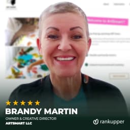 A smiling woman with curly hair, featured on the Rankupper career page, representing team positivity and growth.